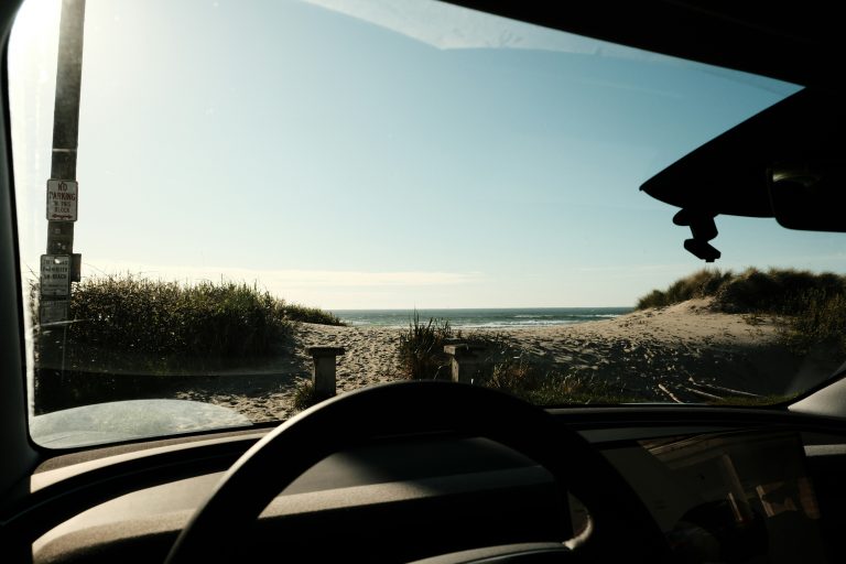 Road seen through a car windshield while driving in the Pacific Northwest